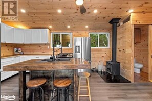 Enjoy cooking in this kitchen with a central island, stove, and ample natural light.