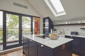 Enjoy a serene kitchen with a central island, oven, and microwave, offering a scenic view of the surrounding area.