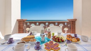 A table set for breakfast with various food items and cups, overlooking a clear blue sky. - 2854 Residence Bellavista - App 6 PP Fronte Mare by Barbarhouse (Porto Cesareo)