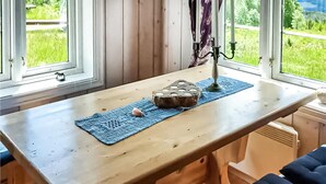A wooden table with a blue placemat, a decorative candle holder, and a loaf of bread. - 2 bedroom gorgeous home in Eggedal (Eggedal)