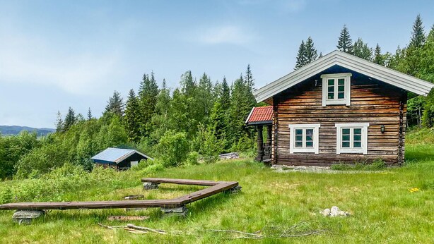A log cabin with a sloped roof, two windows, and a small attached shed. - 2 bedroom gorgeous home in Eggedal (Eggedal)