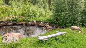 A natural outdoor setting with a small pond, surrounded by rocks and lush greenery. - 2 bedroom gorgeous home in Eggedal (Eggedal)