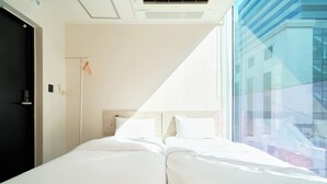 A hotel room with a bed, a window, and a door. - K9 Myeongdong Seoul (Seoul)