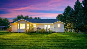 A two-story house with a front porch, a small deck, and a well-maintained lawn. - Peaceful Cul-De-Sac Home, 1 Min. Drive To Zoo MT! (Billings)