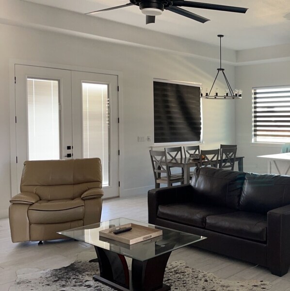 Enjoy a spacious living area with a central island, comfortable seating, and a dining table.
