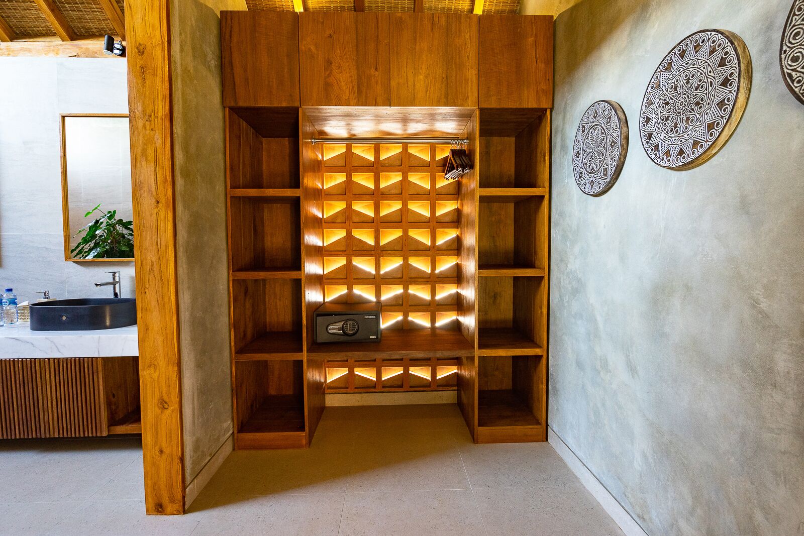 A wooden storage unit with a geometric pattern of shelves and a built-in radio.