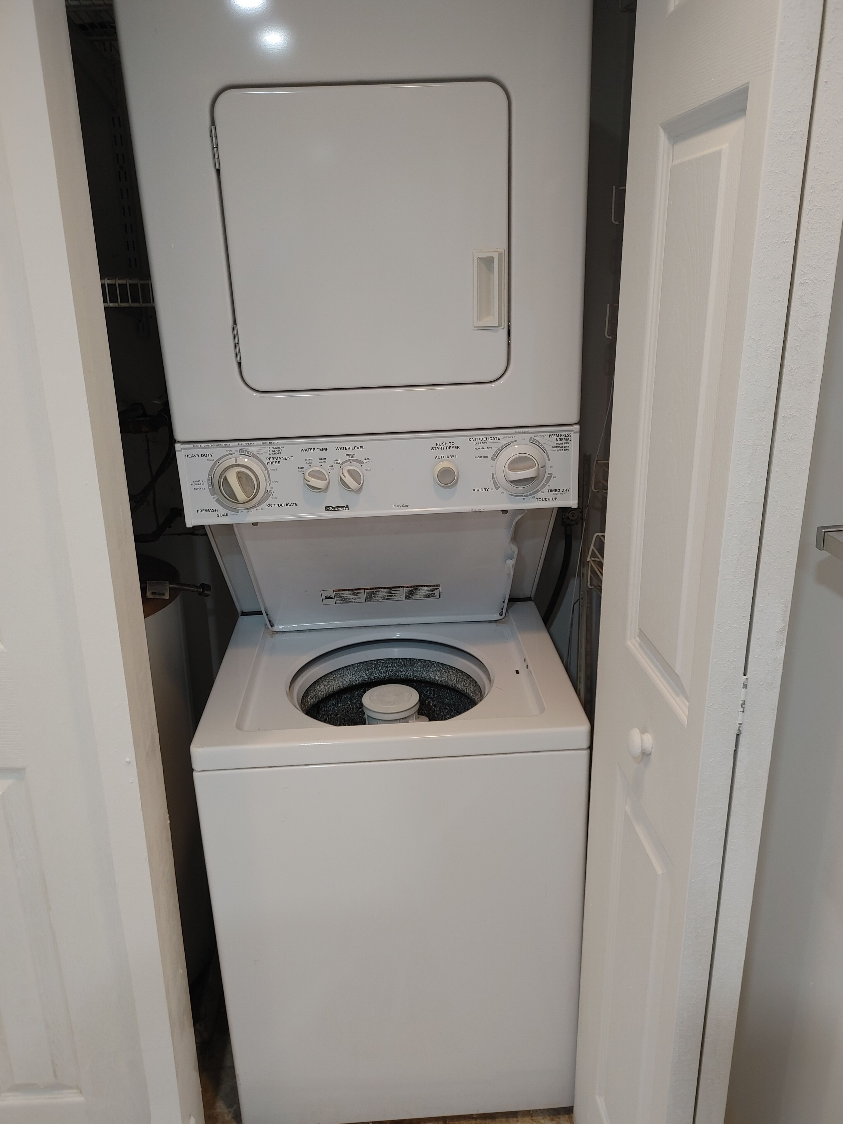 A compact, white, front-loading washing machine with a control panel featuring multiple settings.