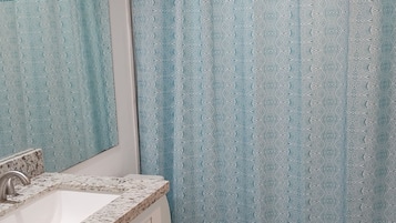 Combined shower/tub, hair dryer, towels, soap