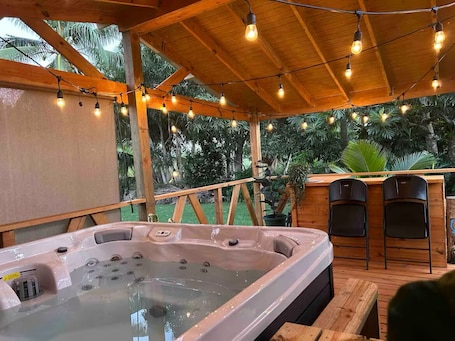 Outdoor spa tub. Imagined Future Guest House - River and beach side house