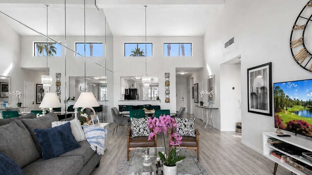 A spacious living area with a sofa, coffee table, and a TV.
