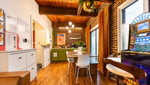 A cozy restaurant with wooden floors, a green counter, and a wheel of fortune game. - Lincoln Park 3BR Townhome • Rooftop • King Suite • Sleeps 10 (Chicago)