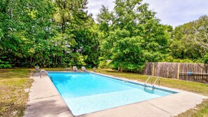 A rectangular swimming pool with a metal ladder, surrounded by a concrete deck. - Pools Paradise: 4  BR, 2  BA House in Wilmington, Sleeps 8 (Wilmington)