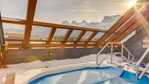 A hot tub with a view of snow-covered mountains. - Heart of Canmore - Pet Friendly with Shared Rooftop Hot Tub (Canmore)
