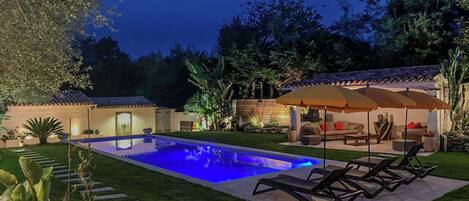 A heated pool, sun loungers