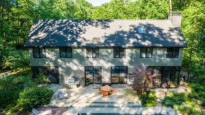A modern house with a large backyard, including a swimming pool and outdoor seating area. - Harbert Home With Private Pool & Hot Tub! Close To Beach!! (Harbert)