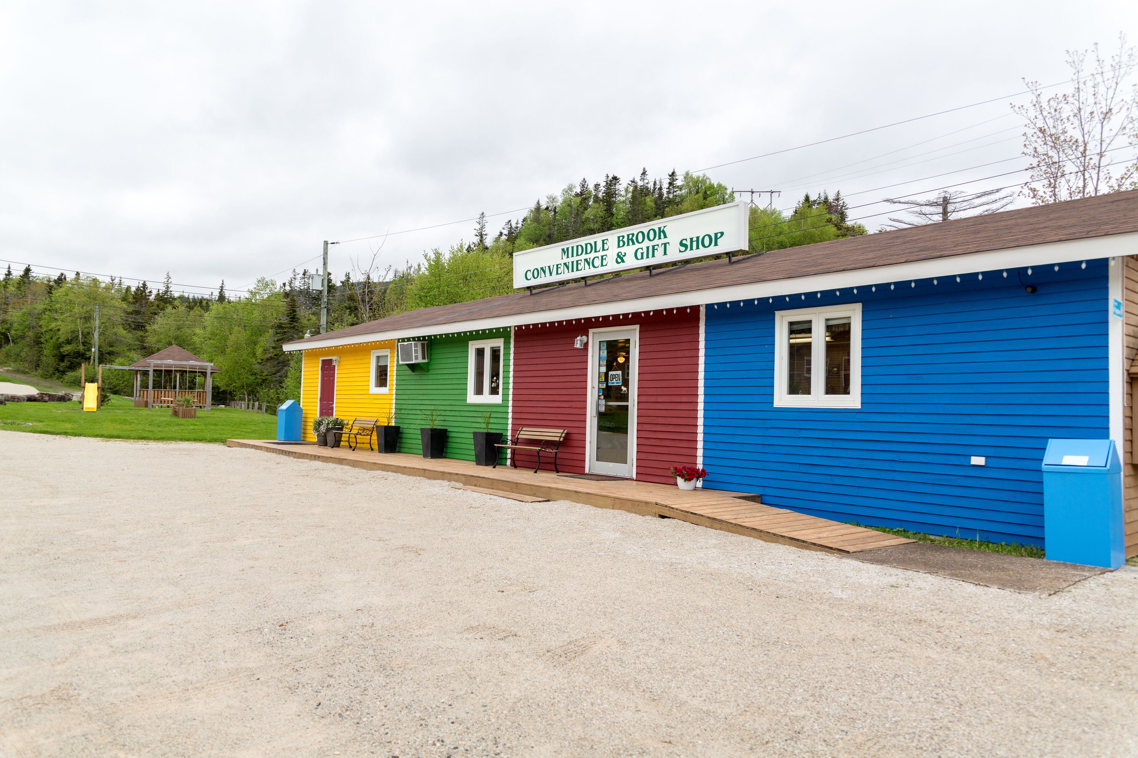 A colorful building with a sign reading "Middle Brook Convenience & Gift Shop."