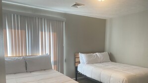 A bedroom with two beds, a window with blinds, and a ceiling vent. - Large group & couples retreat (Pineville)