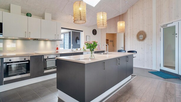 A modern kitchen with a central island, stainless steel appliances, and pendant lighting. - Nice home in Nørre Nebel with sauna (Nørre Nebel)