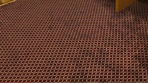A hotel room with a wooden desk, a mirror, a refrigerator, and a patterned carpet. - Hotel  Karam Al Madina (Madinah)