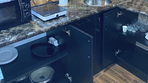 A compact kitchen with a microwave, toaster, and sink. - Green Villa Resort Blue (dilijan)