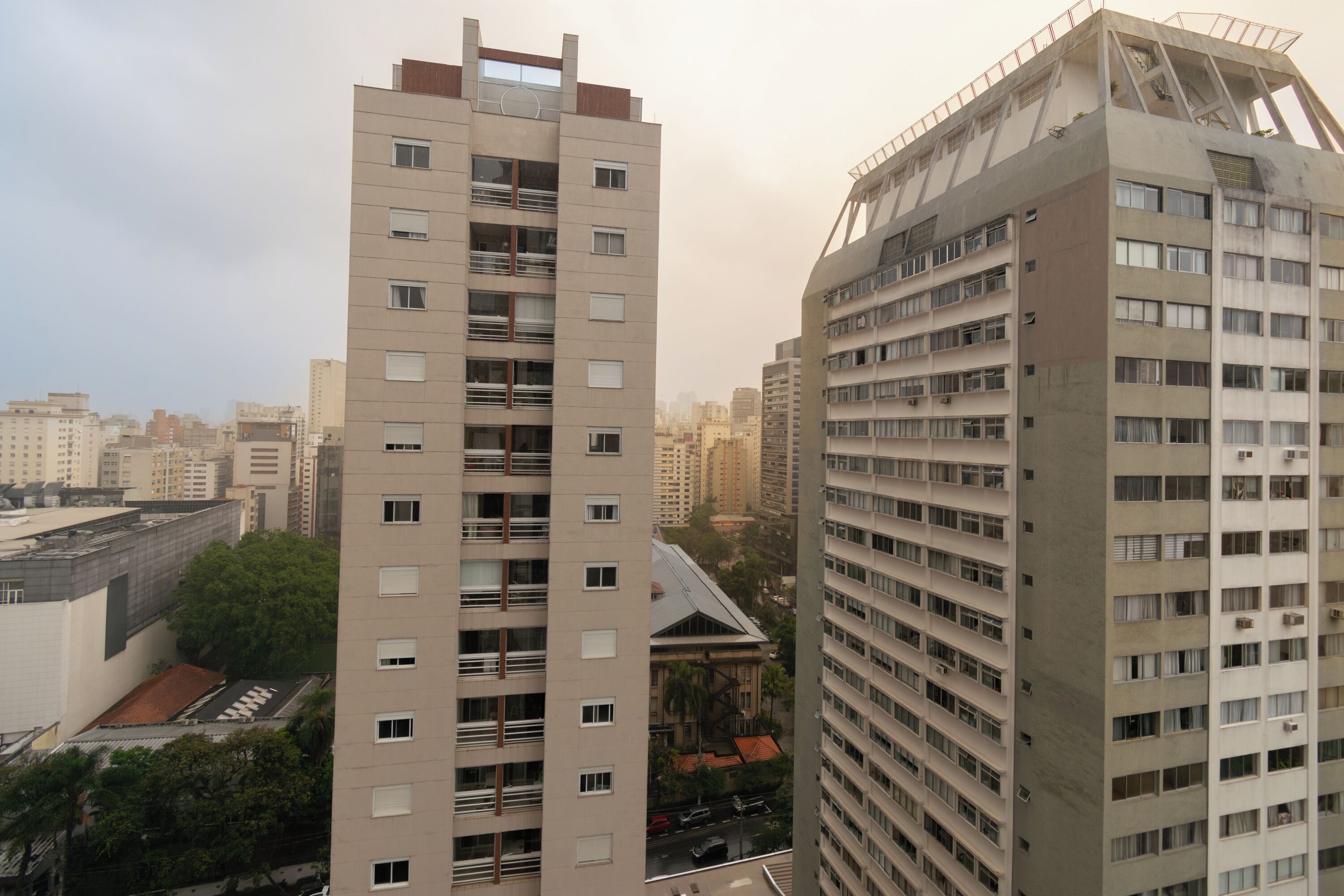 A high-rise building with multiple floors, balconies, and a rooftop terrace.