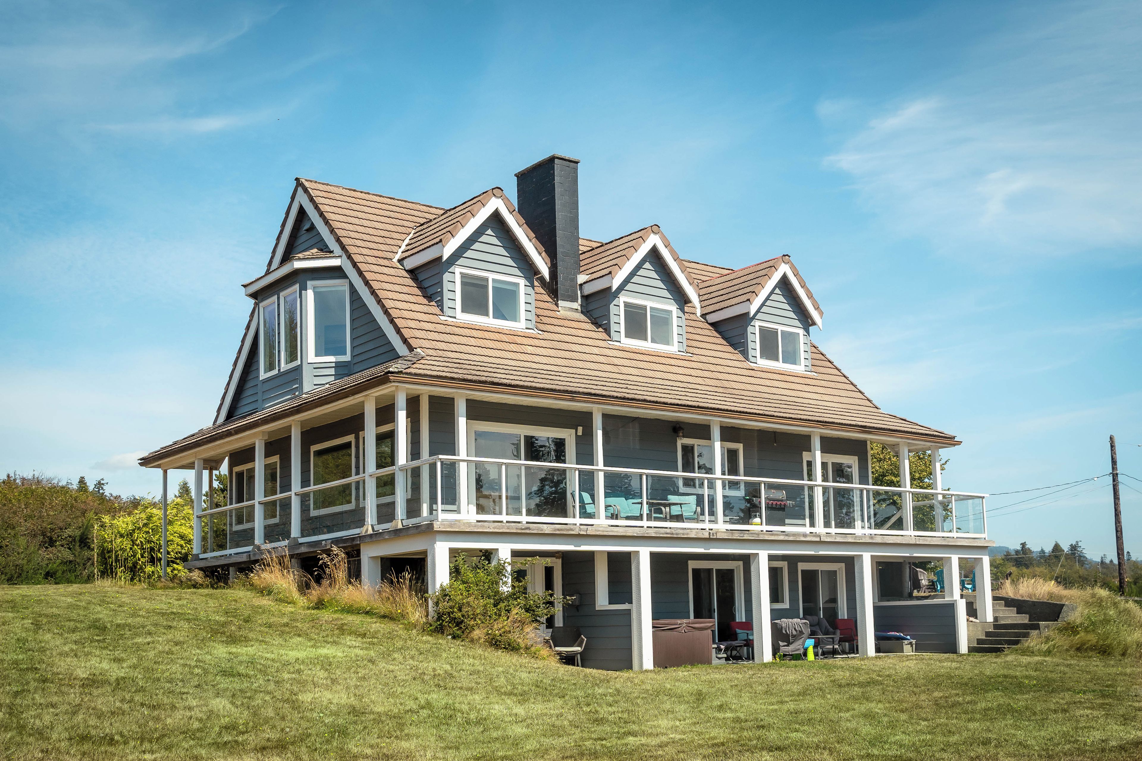 A large two-story house with a wrap-around porch and a covered front entrance.