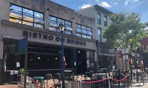 A restaurant named Bistro on Bridge with outdoor seating and a red rope barrier. - New Spacious single w/ parking.  Bikes, XBOX, (Phoenixville)