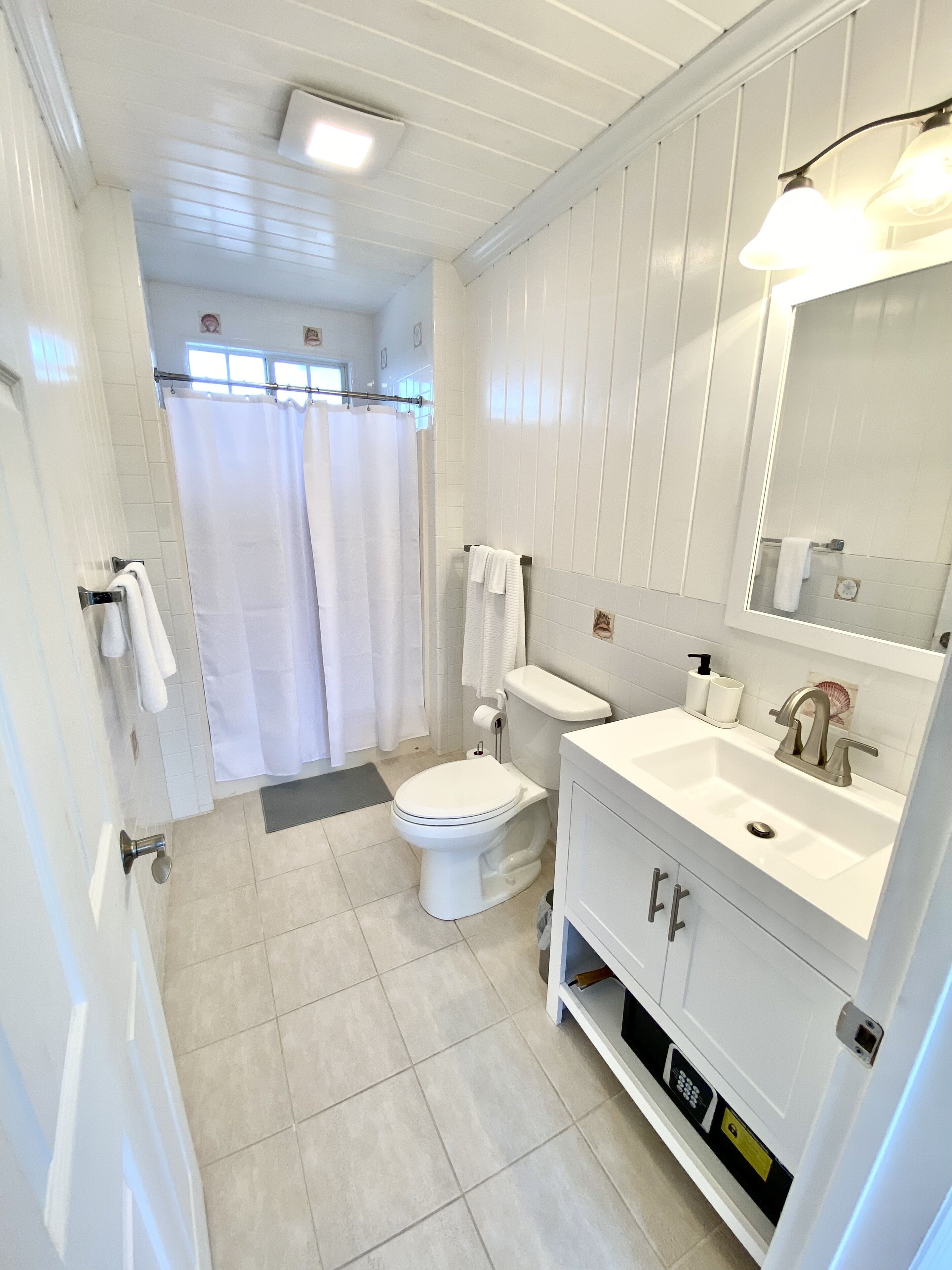 Shower, hair dryer, towels, toilet paper