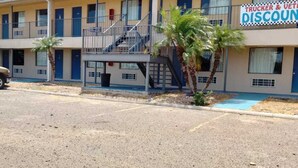 A motel with a two-story structure, a covered outdoor area, and a sign advertising trucker and veteran discounts. - Pharr Executive Inn good clean place for the price. near Airport, restaurants  (Pharr)