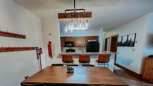 A modern kitchen with wooden cabinets, a microwave, and a black refrigerator.