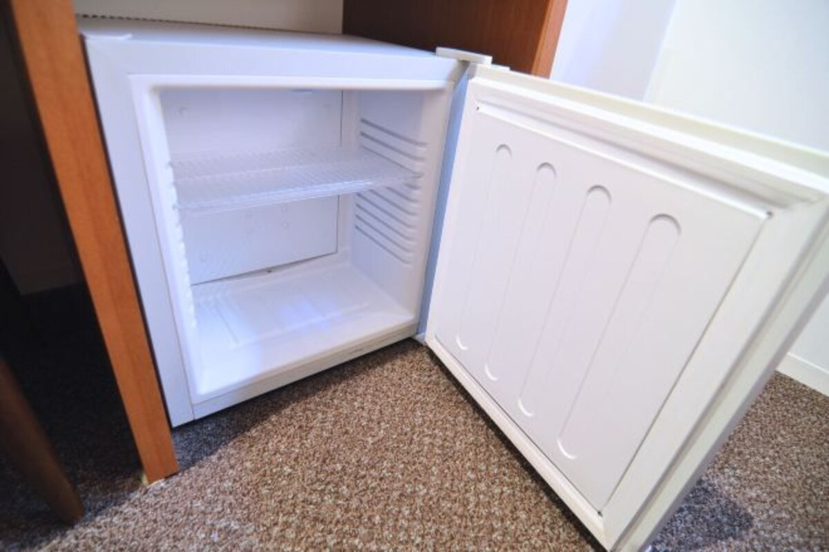 An open refrigerator with multiple shelves and a freezer compartment.