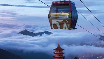 A cable car with a traditional pagoda in the foreground.