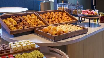 A buffet with various pastries and desserts.