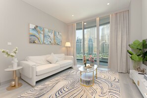Relax in a stylish living room with a sofa, side table, and coffee table, offering a view of high-rise buildings.