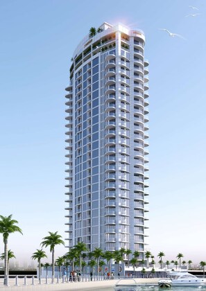 Experience the unique curved facade of the Condor hotel, offering stunning views and balconies.