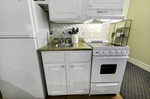 Fridge, microwave, coffee/tea maker, cookware/dishes/utensils