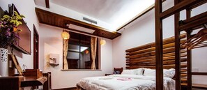A bedroom with a wooden headboard, a bed with white bedding, a window with curtains, and a wooden chair. - Hotel California Zhangjiajie (Zhangjiajie)