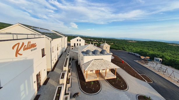 A resort with a clear view of the surrounding landscape, including a road and distant hills. - Kalima resort (Mostar)