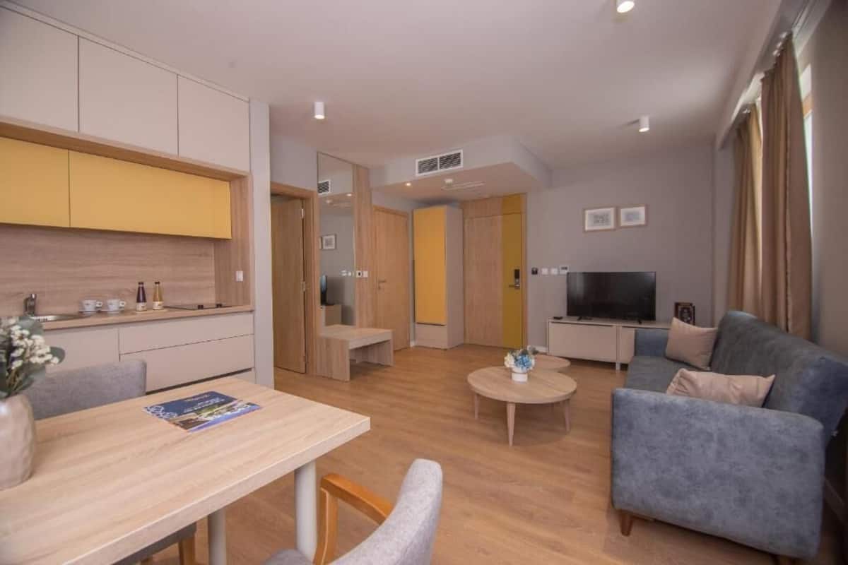 Deluxe Apartment | Living area | 50-cm LCD TV with cable channels, TV, printers