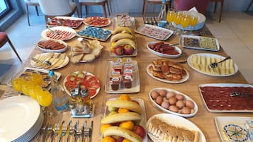 A breakfast buffet with various food items and beverages.