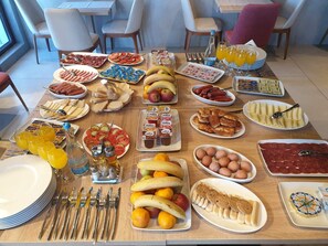 A breakfast buffet with various food items and beverages.