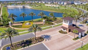A golf course with a water feature, a central building, and surrounding residential areas.