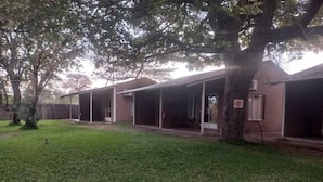 A single-story building with a covered porch and a lawn in front.