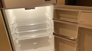 An open refrigerator with three shelves and a freezer compartment. - Windham getaway!  (Windham)