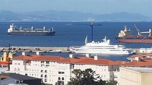 A coastal cityscape with a large cruise ship docked at a port, a cargo ship, and industrial cranes in the background. - Charming Colonial Flat in historic building (Castle Road)