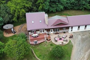 Stunning two-story building with a covered patio and beautifully manicured lawn.