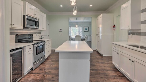 A modern kitchen with white cabinets, stainless steel appliances, and a central island. - Jackson Getaway + Yard, 4 Mi to High Falls SP (Jackson)