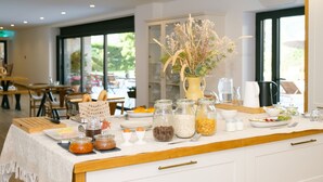 A breakfast buffet setup with various food items and condiments. - Casa Vieira Lobo (Arouca)