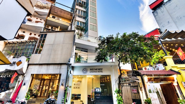 A multi-story building with a prominent hotel entrance labeled "Memory Legends Hotel." - HANZ Hotel Memory Hanoi (Hanoi)