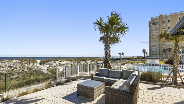 A rooftop terrace with outdoor furniture, a swimming pool, and a view of the beach and ocean. - Beachside! Jacksonville Beach Condo-Close to Mayo Clinic (Jacksonville Beach)